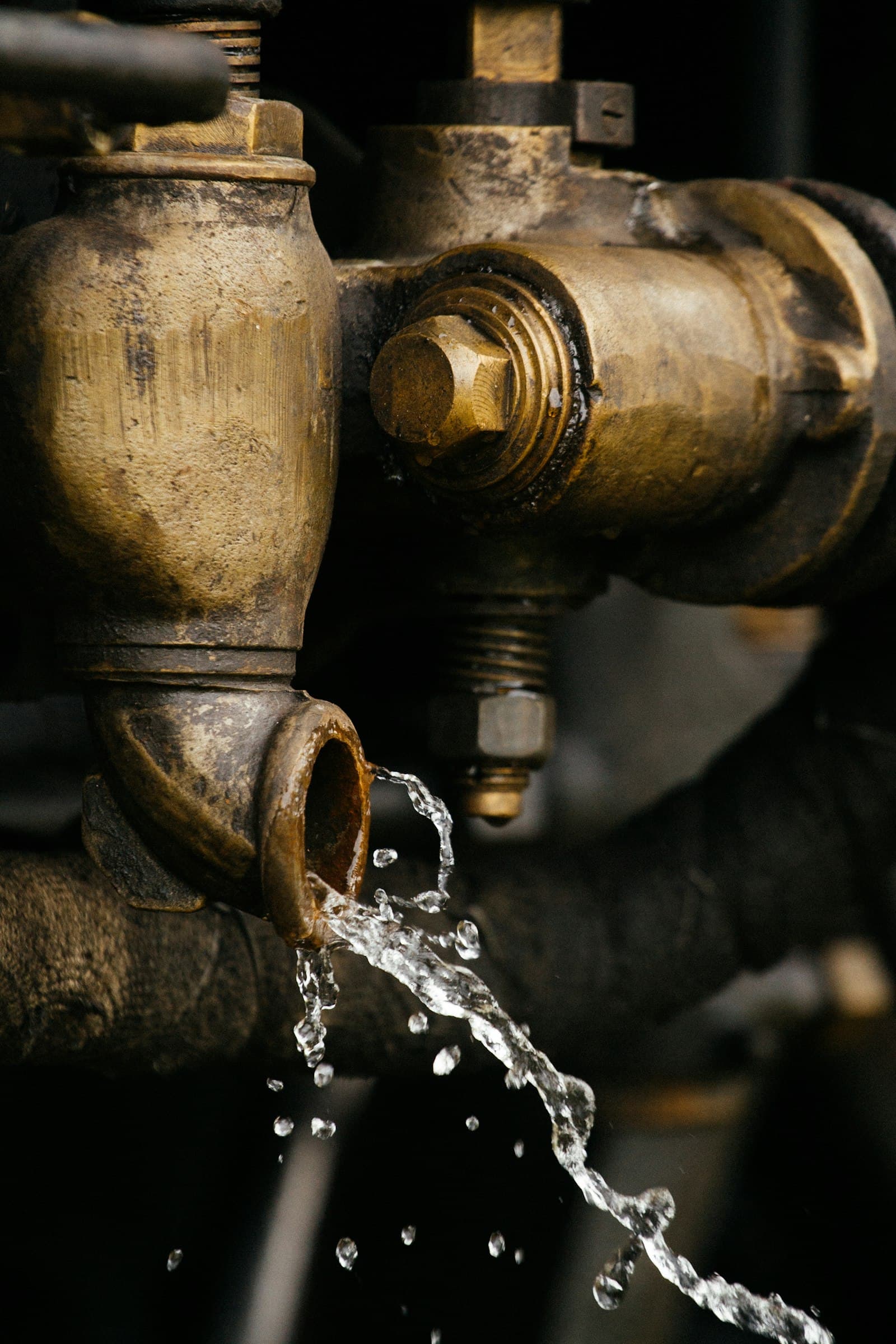 Close-up of a copper pipe joint with a water leak