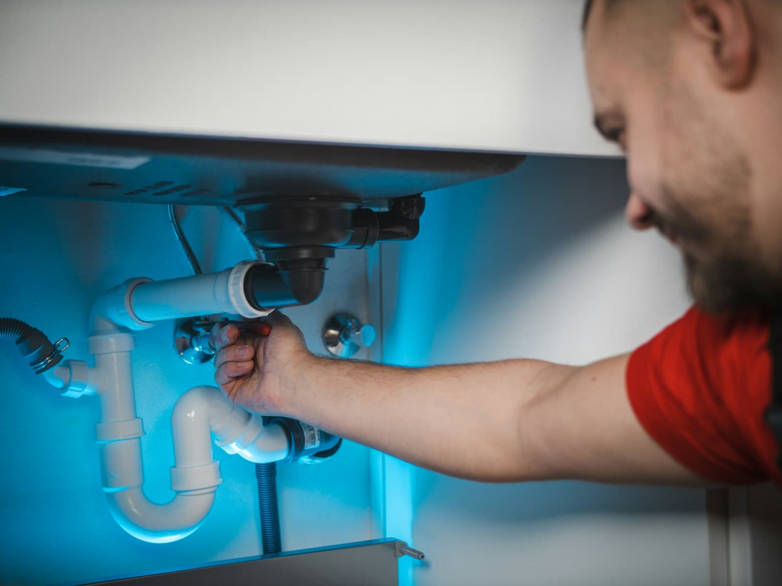 Technician using leak detection equipment